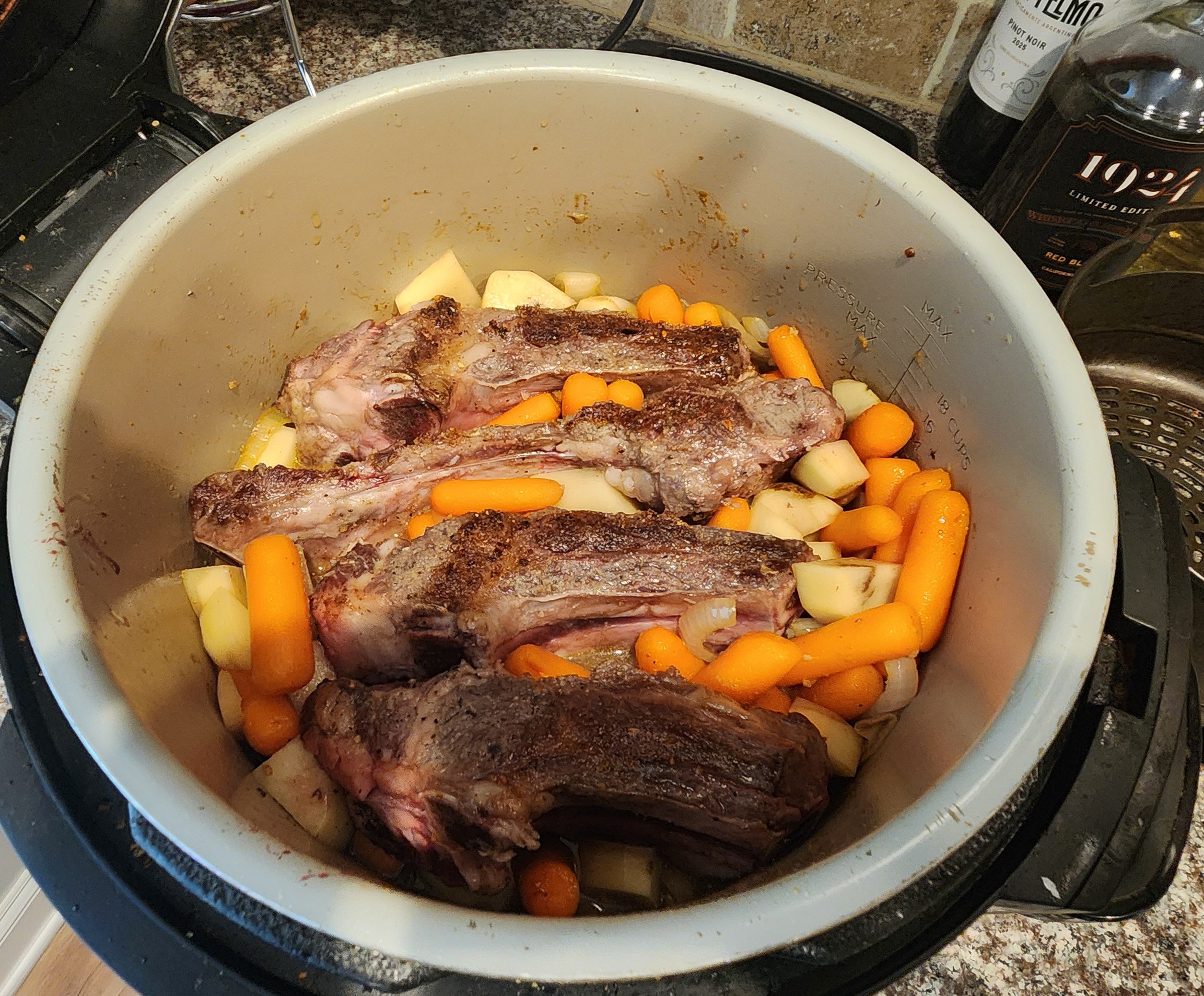 Beef short ribs and vegetables in the InstaPot before cooking